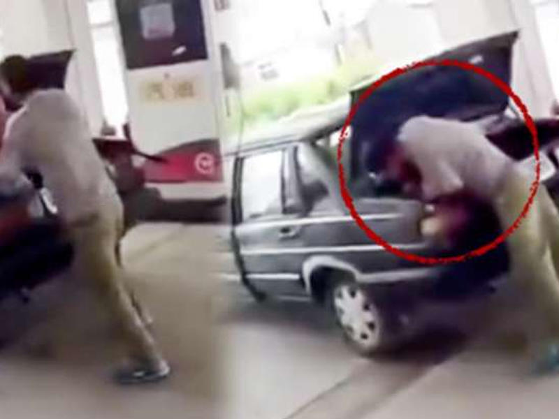 Həyat yoldaşını zorla maşının baqajına saldı - VİDEO