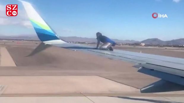 Uçuşa hazırlaşan təyyarənin qanadına dırmaşdı - VİDEO