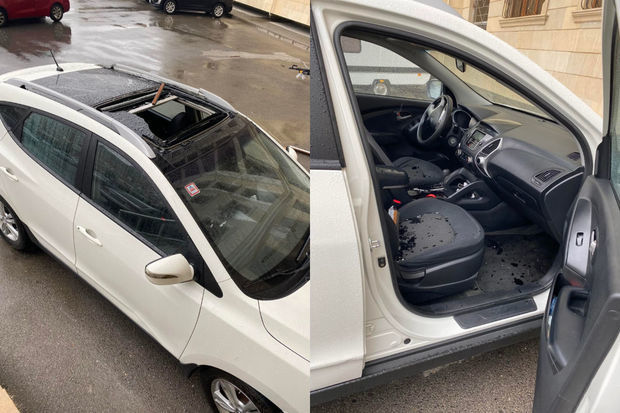 В Баку вырванная ветром оконная рама повредила крышу автомобиля - ФОТО