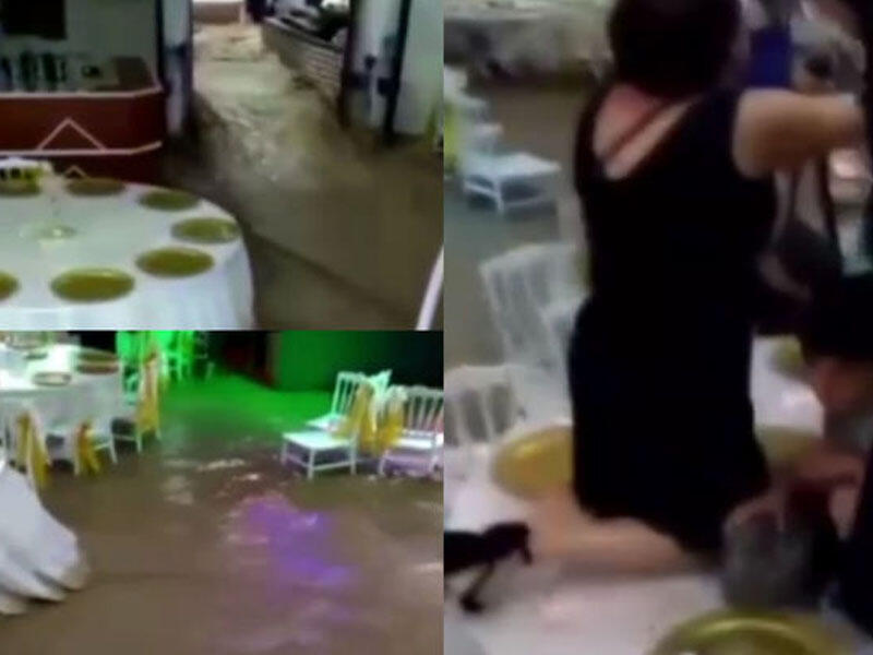 Toyda masanın üstünə çıxaraq seldən xilas olmağa çalışdılar - VİDEO