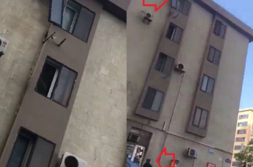 Bakıda binanın sınmış pəncərə şüşəsi təhlükə saçır - VİDEO